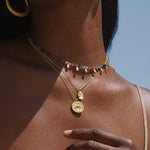 Model elegantly wearing the Favored by Fortune Ganesha Necklace with colorful beads, combining spiritual aesthetics with the themes of the sun, moon, and zodiac in a meaningful representation.