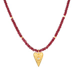 Healing Heart Red Onyx Heart Necklace featuring red onyx beads and a golden heart pendant with white topaz, representing love and protection in spiritual jewelry. Perfect for meditation, this meaningful talisman embodies the essence of manifestation, making it ideal for yoga and mindfulness practices.