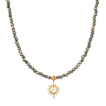 Dreams of Prosperity Pyrite Necklace featuring gleaming pyrite beads and a golden starburst moonstone pendant. This spiritual jewelry embodies the essence of prosperity and clarity, perfect for meditation or yoga practices. A meaningful talisman for manifestation and protection, this necklace resonates with the energies of the sun and moon, making it a great piece for zodiac enthusiasts.