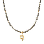 Dreams of Prosperity Pyrite Necklace featuring gleaming pyrite beads and a golden starburst moonstone pendant. This spiritual jewelry embodies the essence of prosperity and clarity, perfect for meditation or yoga practices. A meaningful talisman for manifestation and protection, this necklace resonates with the energies of the sun and moon, making it a great piece for zodiac enthusiasts.
