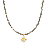 Dreams of Prosperity Pyrite Necklace featuring gleaming pyrite beads and a golden starburst moonstone pendant. This spiritual jewelry embodies the essence of prosperity and clarity, perfect for meditation or yoga practices. A meaningful talisman for manifestation and protection, this necklace resonates with the energies of the sun and moon, making it a great piece for zodiac enthusiasts.