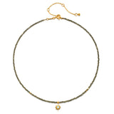 Dreams of Prosperity Pyrite Necklace featuring gleaming pyrite beads and a golden starburst moonstone pendant. This spiritual jewelry embodies the essence of prosperity and clarity, perfect for meditation or yoga practices. A meaningful talisman for manifestation and protection, this necklace resonates with the energies of the sun and moon, making it a great piece for zodiac enthusiasts.