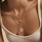 A close-up of the In Pursuit of Peace Necklace layered with other jewelry pieces, reflecting spirituality and meaningful vibes for yoga and protection.
