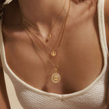 A close-up of the In Pursuit of Peace Necklace layered with other jewelry pieces, reflecting spirituality and meaningful vibes for yoga and protection.