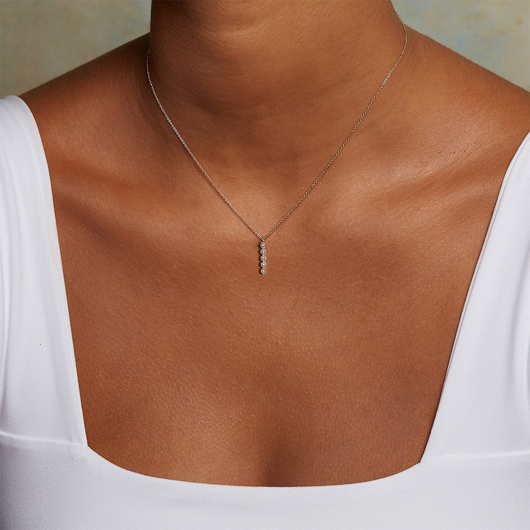 Eternal Light Diamond 14kt Gold Necklace worn elegantly, highlighting the exquisite design with five sparkling diamonds. This piece serves as a spiritual jewelry statement, ideal for those engaging in meditation, yoga, and seeking a powerful symbol for manifestation and protection.