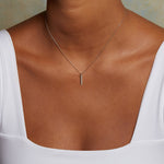 Eternal Light Diamond 14kt Gold Necklace worn elegantly, highlighting the exquisite design with five sparkling diamonds. This piece serves as a spiritual jewelry statement, ideal for those engaging in meditation, yoga, and seeking a powerful symbol for manifestation and protection.