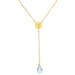 Speak with Strength Chakra Lariat Necklace featuring a golden flower motif and a blue topaz drop, symbolizing communication and honesty in spiritual jewelry and meditation, ideal for yoga and meaningful manifestation.
