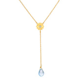 Speak with Strength Chakra Lariat Necklace featuring a golden flower motif and a blue topaz drop, symbolizing communication and honesty in spiritual jewelry and meditation, ideal for yoga and meaningful manifestation.
