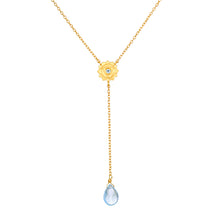 Speak with Strength Chakra Lariat Necklace featuring a golden flower motif and a blue topaz drop, symbolizing communication and honesty in spiritual jewelry and meditation, ideal for yoga and meaningful manifestation.