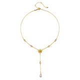 Gold-toned lariat necklace with lotus flower pendant, pearls, and teardrop stone drop.