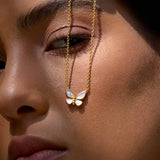 A person wearing the Renewed Hope Pearl Butterfly Necklace, showcasing the elegant butterfly pendant with mother of pearl. This spiritual jewelry piece embodies meaning and is ideal for meditation, serving as a talisman for those embracing transformation, protection, and manifestation in their yoga journey.