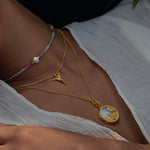 The Loving Devotion Hummingbird Necklace layered with other necklaces on a model, emphasizing its versatility in spiritual jewelry and its role as a meaningful piece for yoga and meditation practices.