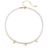 Close-up of the Blooming Promise Lotus Pearl Necklace featuring rice freshwater pearls and delicate gold leaves; perfect for those who embrace spirituality, zodiac meanings, and the guiding essence of wearing talismans in meditation and protection.