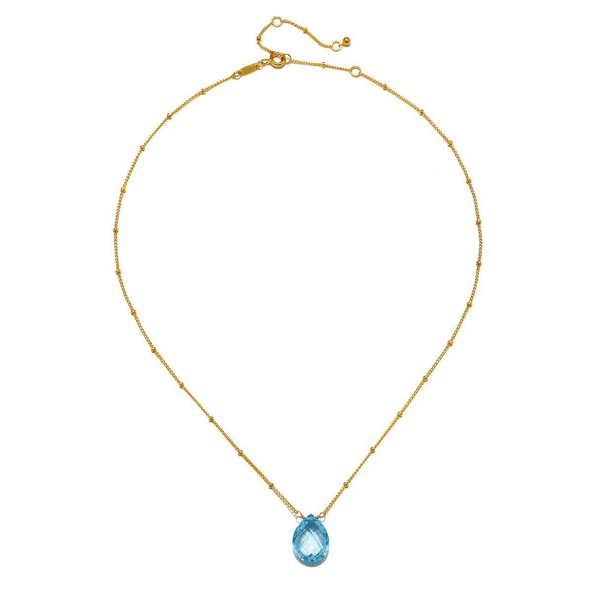 Sleek presentation of the Blessed Abundance Blue Topaz Necklace highlighting the 18kt gold plated design, an enchanting piece for spiritual growth and manifestation.