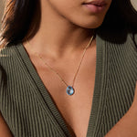 Close-up view of a woman wearing the Blessed Abundance Blue Topaz Necklace, embodying elegance in spiritual jewelry while enhancing communication and meaningful connections.