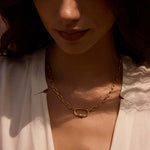 Close-up of a model wearing the New Beginnings Lotus Charm Holder Necklace, highlighting its exquisite design and golden hue. This talisman serves as a beautiful reminder of spiritual growth and connection, ideal for yoga and meditation practices.