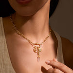 The New Beginnings Lotus Charm Holder Necklace adorned with charms, showcasing its versatility and symbolic meaning. This piece is perfect for manifestation and adds a touch of spiritual elegance to any outfit, ideal for those into zodiac and meditation.