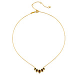The Ignite Strength Garnet Petal Necklace displayed elegantly, highlighting its intricate design alongside spiritual jewelry elements, making it a perfect talisman for meditation and transformation.