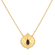 Grounded in Strength Garnet Lotus Necklace featuring a delicate 18kt gold plate pendant with a finely etched lotus and a faceted garnet, symbolizing new beginnings and strength; perfect for spiritual jewelry, meditation, and manifestation.