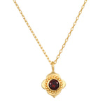 A close-up view of the Spiritual Strength Garnet Lotus Necklace featuring an intricately designed lotus pendant with a garnet stone. This elegant piece of spiritual jewelry serves as a talisman, embodying themes of meditation and meaningful manifestation, perfect for yoga and wellness enthusiasts seeking protection and grounding energy.