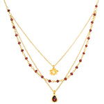 Embrace Change Garnet Lotus Triple Necklace displayed on a white background, showcasing its elegant design with garnet beads and a lotus pendant. This spiritual jewelry piece embodies the themes of transformation and renewal, making it perfect for meditation and manifestation practices. Ideal for those who seek meaningful connections in their spiritual journey.