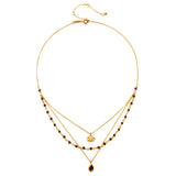 Embrace Change Garnet Lotus Triple Necklace, crafted with an 18kt gold plate and stunning garnet beads, represents transformation and grounding energy, perfect for spiritual jewelry associated with meditation, talismans, zodiac signs, and meaningful manifestations in yoga practices.
