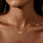 Close-up view of the Ignite Intuition White Topaz Evil Eye Necklace worn, highlighting its golden charm and spiritual meaning, ideal for yoga and meaningful moments of reflection.