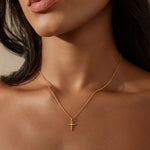 A model wearing the Honor Your Faith Cross White Topaz Necklace, showcasing its elegant design against the skin. Ideal for yoga and meditation practices, this spiritual jewelry serves as a protective reminder of love and faith, enhancing the wearer’s journey.