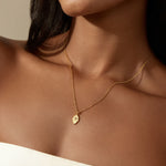 Close-up of a woman wearing the Protective Hand White Topaz Hamsa Necklace, showcasing the delicate design of the hamsa hand pendant. This spiritual jewelry piece serves as a protective talisman, aligning with themes of manifestation, meditation, and meaningful energy in one's spiritual journey.