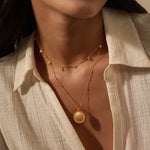 Intention of Guidance Necklace Set worn by a model, showcasing the golden choker and pendant layered elegantly, representing spiritual connection, zodiac themes, and the essence of sun and moon.