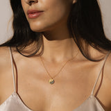 Model displaying the Celestial Balance Yin Yang White Topaz Necklace, radiating elegance and meaning. This necklace is a beautiful piece of spiritual jewelry that fosters a sense of protection and harmony, ideal for yoga and meditation.