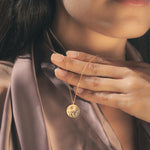 Close-up of the Celestial Balance Yin Yang White Topaz Necklace, highlighting its intricate sun and moon details. A perfect talisman for those seeking spiritual connection, manifestation, and the balance of energies in their life.