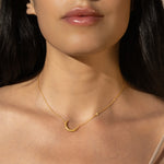 Ethereal Guide Moonstone Moon and Star Necklace worn by a model, showcasing its beauty as spiritual jewelry. The crescent moon and star design represents meditation and meaning in one's spiritual life. Ideal for those seeking a talisman for protection and manifestation, complementing a yoga practice.
