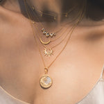 Layered necklaces including the Ethereal Guide Moonstone Moon and Star Necklace, offering a stunning collection of spiritual jewelry that represents the sun, moon, and zodiac. Each piece is meaningful, perfect for meditation and manifestation, adding depth to a yoga-themed look.