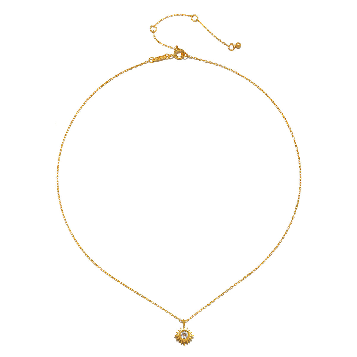 The Clarity White Topaz Starburst Necklace displayed elegantly against a neutral background, representing a meaningful piece of spiritual jewelry that inspires clarity, protection, and connection to the sun and moon.