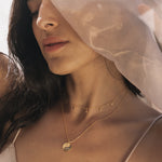 Profile view of a model adorned with the Enchanted Journey Celestial Choker Necklace, radiating an aura of tranquility. This spiritual jewelry is a beautiful talisman for yoga practitioners, representing the sun, moon, and the art of manifestation.