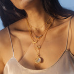 Close-up of the Enchanted Journey Celestial Choker Necklace layered with other spiritual jewelry, featuring celestial motifs ideal for meditation and symbolizing the zodiac. Its elegant design embodies protection and meaningful connection to the sun and moon.