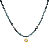 Channeling Wisdom Sapphire Starburst Beaded Choker, a beautiful piece of spiritual jewelry featuring delicate sapphire beads and an 18kt gold plated starburst pendant. Ideal for meditation and as a talisman, this choker embodies the essence of zodiac symbolism, protection, and meaningful manifestation in your yoga and spiritual practices.