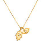 Gold-toned chain necklace with two hamsa hand pendants featuring crystal centers.