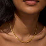 A close-up of the Shine a Light Coin Chain Necklace worn around the neck, symbolizing meaningful expression and connection to the sun and moon through spiritual jewelry and meditation.