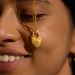 Close-up of a woman wearing the Love Everlasting Padlock Heart Necklace, featuring a heart-shaped pendant adorned with a white topaz, symbolizing love and clarity. This beautiful piece represents spiritual jewelry and meaningful manifestation, perfect for meditation and protection.