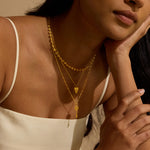 A model wearing the Key to My Heart White Topaz Key Necklace layered with other spiritual jewelry, creating a thoughtful display of personal meaning. This elegant style suits practices like yoga and meditation and enhances your manifestation journey with its cosmic charm, connecting the sun and moon energies.