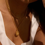 A lifestyle shot of the Infinite Devotion White Topaz Spinner Mandala Necklace worn gracefully, highlighting its elegance and connection to yoga and spirituality. This jewelry piece acts as a meaningful talisman, enhancing meditation practices and personal manifestation.