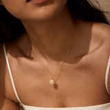 A model wearing the Journey to Love Moonstone Lotus Heart Necklace, showcasing its elegant design featuring a moonstone heart pendant. A piece of meaningful spiritual jewelry that connects with meditation and offers protection during personal growth and manifestation journeys.
