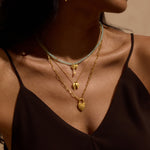 Close-up of the Love Everlasting Padlock Heart Necklace styled with other gold pieces, embodying the essence of spiritual jewelry, perfect for yoga and meaningful manifestation.