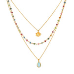 Transformed by Love Tourmaline Agate Lotus Triple Necklace showcasing a delicate design with colorful tourmaline and blue agate stones, perfect for spiritual jewelry enthusiasts seeking meaningful adornments for meditation, yoga, and manifestation.