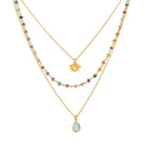 Transformed by Love Tourmaline Agate Lotus Triple Necklace showcasing a delicate design with colorful tourmaline and blue agate stones, perfect for spiritual jewelry enthusiasts seeking meaningful adornments for meditation, yoga, and manifestation.