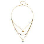 Close-up of the Transformed by Love Tourmaline Agate Lotus Triple Necklace that features an elegant lotus charm atop layered agate and tourmaline stones, perfect for those seeking meaningful spiritual jewelry for protection and manifestation.