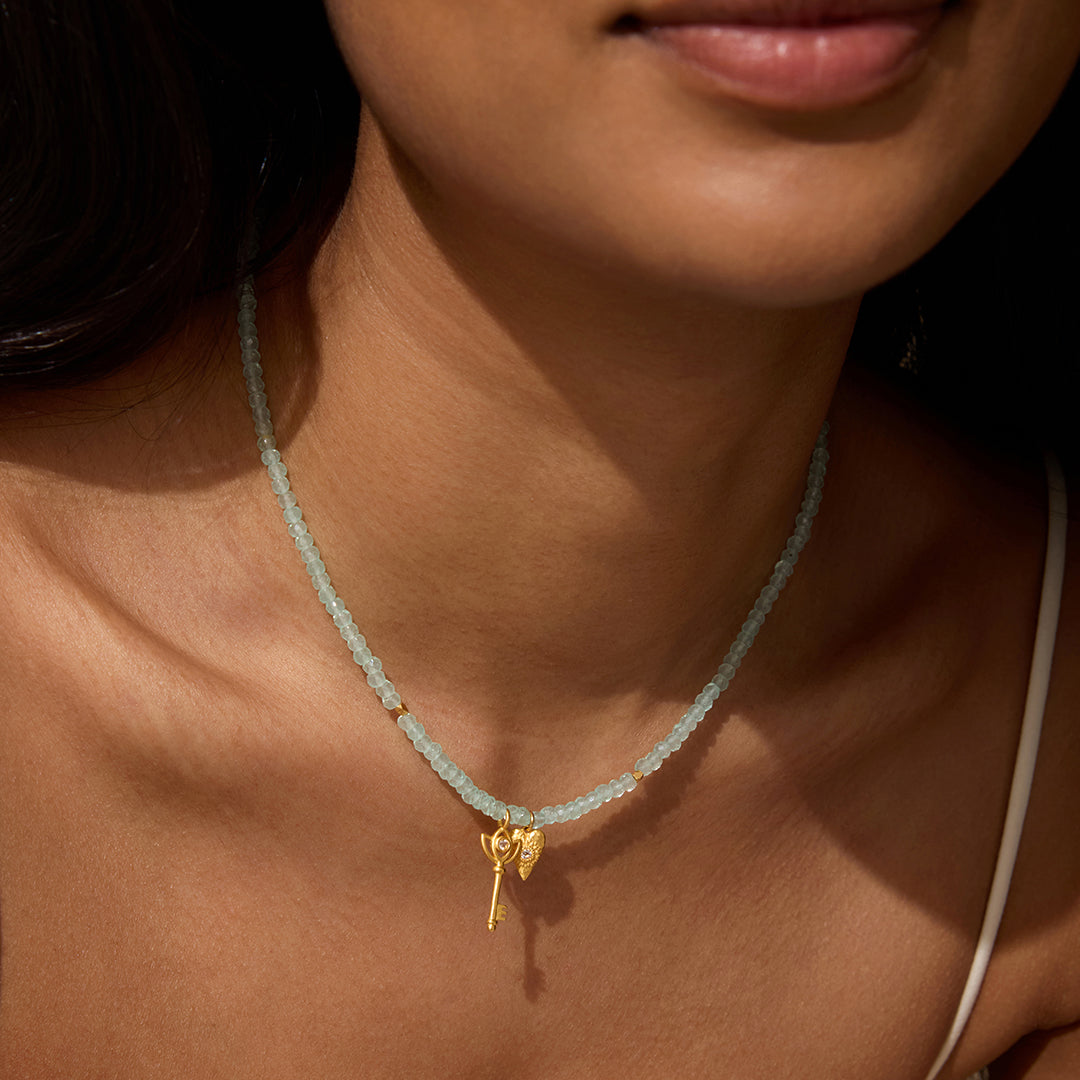 Close-up of the Love Unlocked Chalcedony Beaded Key Heart Necklace worn by a model, highlighting its beauty and charm as a piece of spiritual jewelry. This necklace symbolizes love and meaningful connections, serving as a talisman for meditation and empowering those who practice yoga.