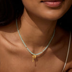 Close-up of the Love Unlocked Chalcedony Beaded Key Heart Necklace worn by a model, highlighting its beauty and charm as a piece of spiritual jewelry. This necklace symbolizes love and meaningful connections, serving as a talisman for meditation and empowering those who practice yoga.